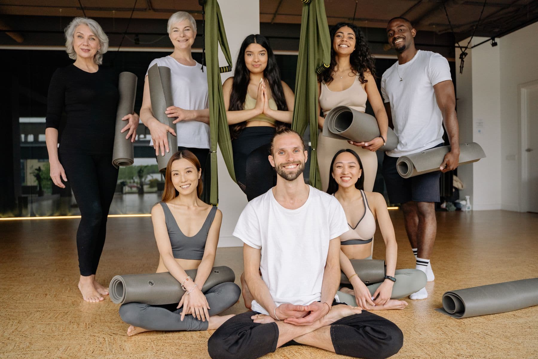 A diverse group of studio members together after class