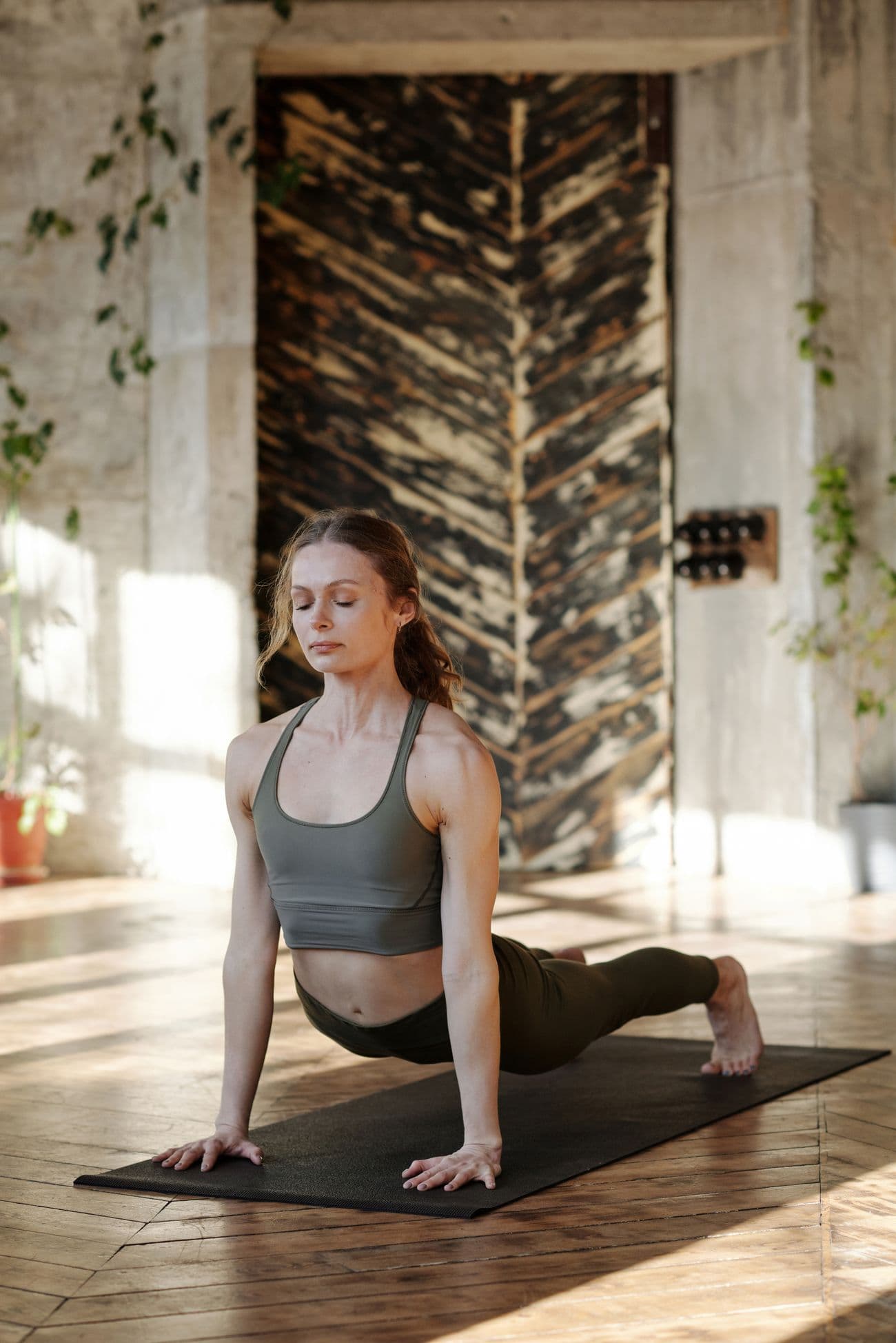 A studio member mid-practice in a calm, sunlit space
